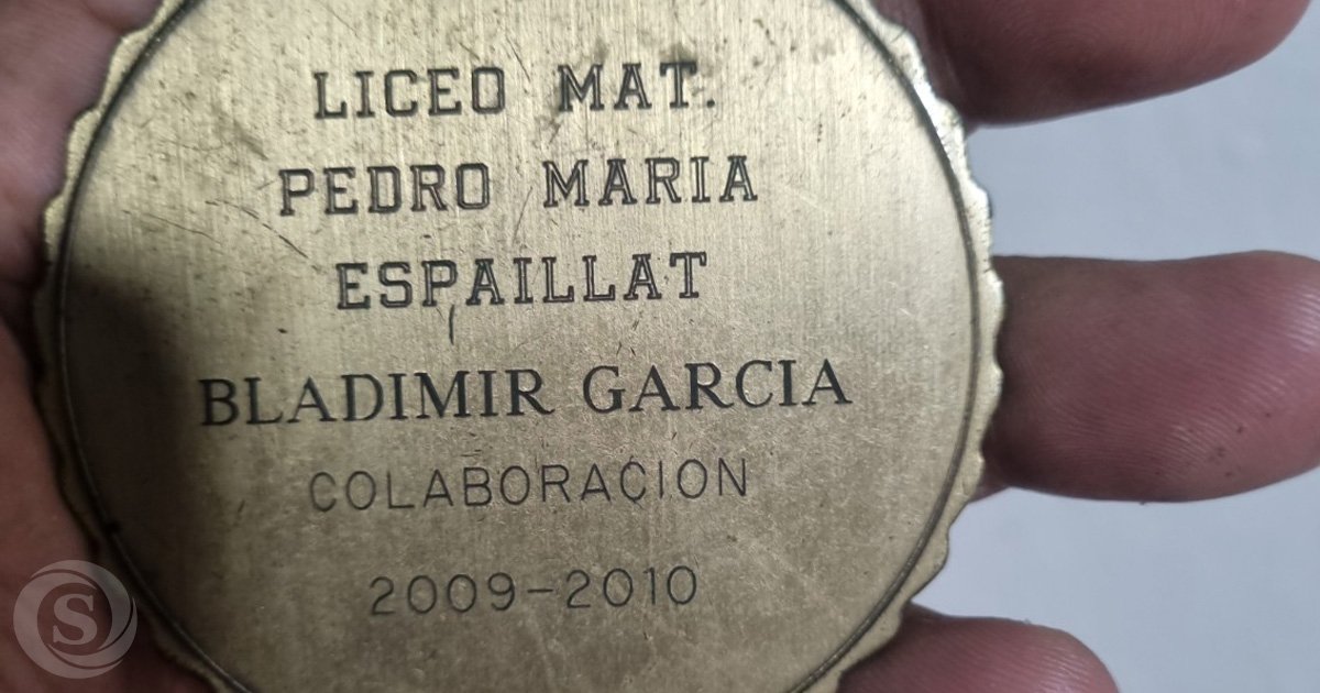 Primer plano de una medalla de reconocimiento otorgada por el Liceo Matutino Pedro María Espaillat a Bladimir García por su colaboración durante el período escolar 2009-2010.